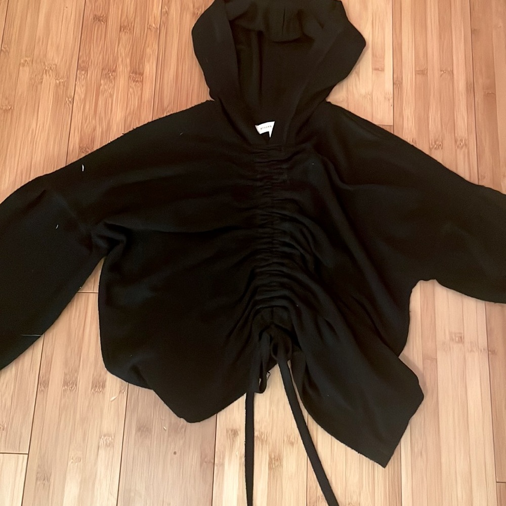 Gilded intent black cropped hoodie with draw string down the front.